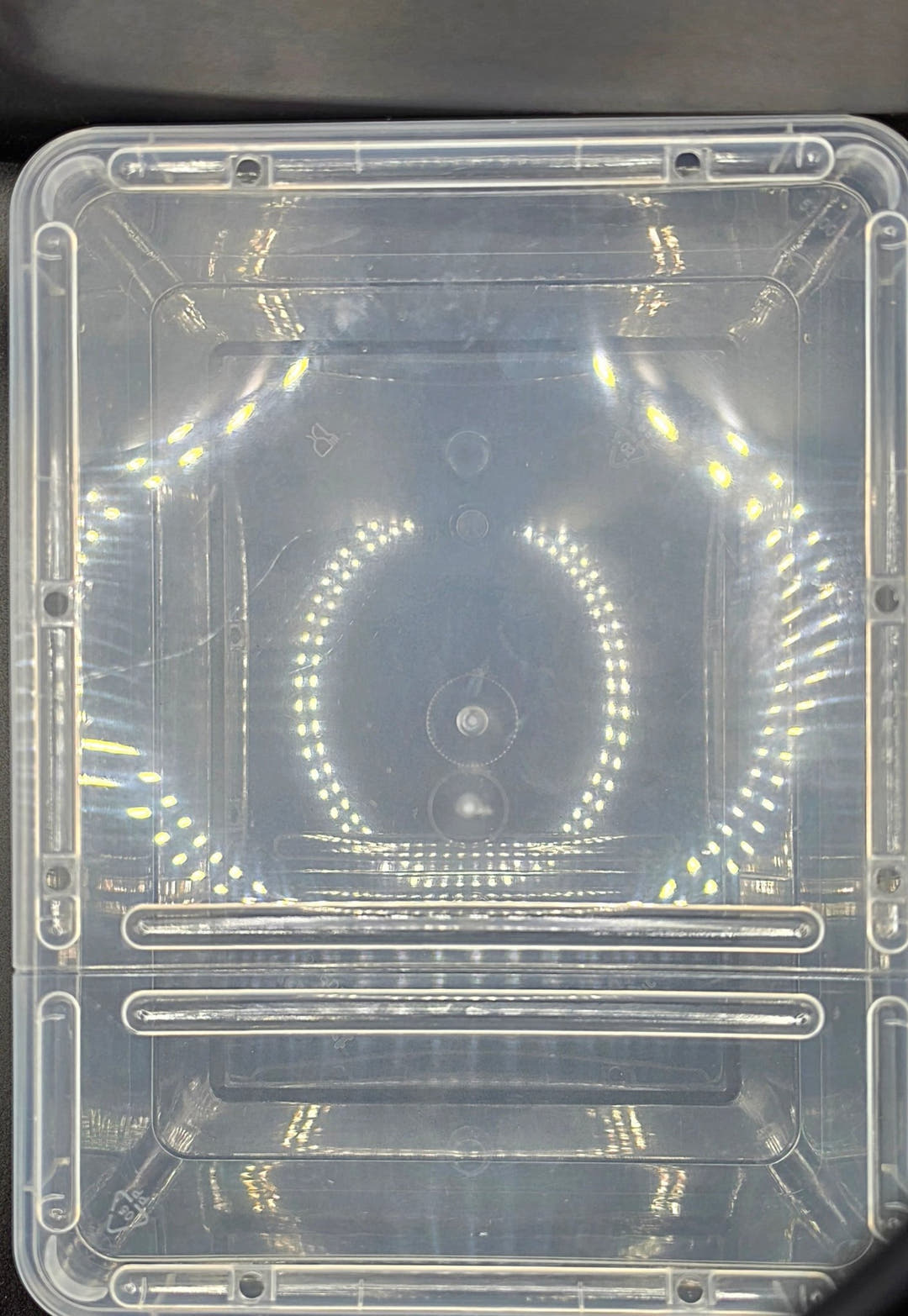 Close view of the clear Braplast lid filling the frame, showing its two long vent sliders.