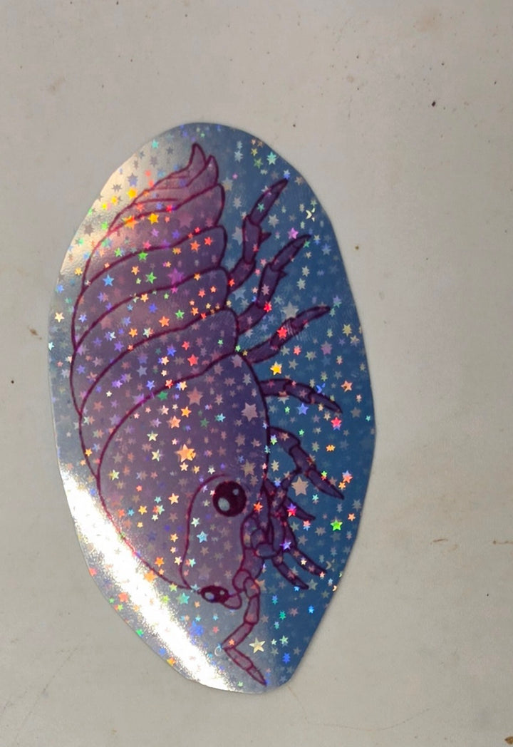 Cherry Blossom isopod sticker: a lilac-pink isopod drawn side-on with big dark eyes, covered in holographic stars.