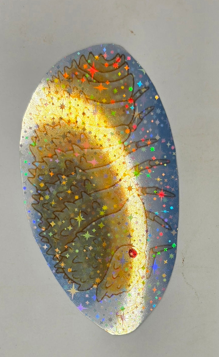 Crystal Pineapple isopod sticker: a golden isopod fringed with spines, with a red eye, shimmering on holographic star vinyl.