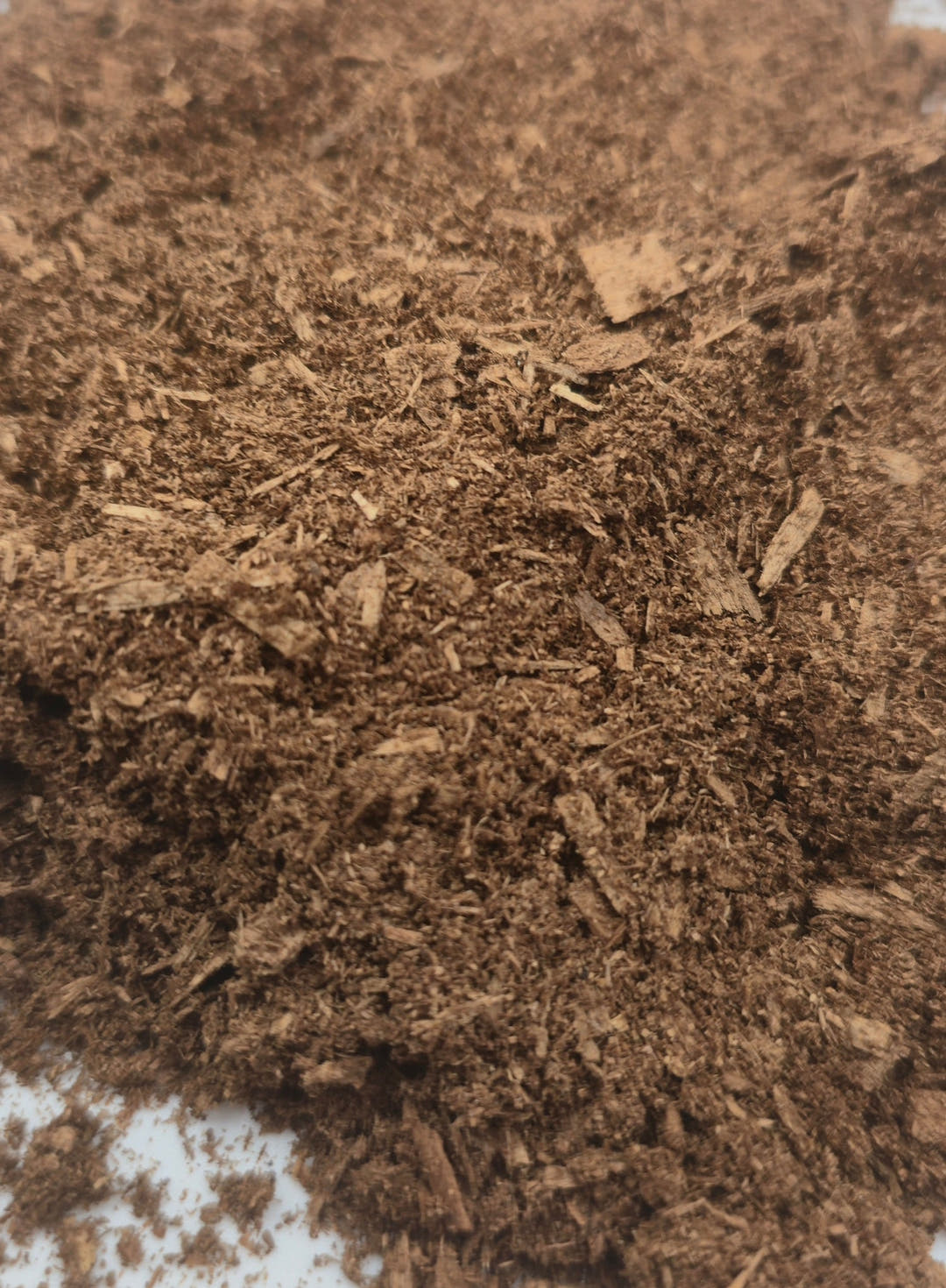 Flake soil, darker and softer and richer in nitrogen than the wood that went into it