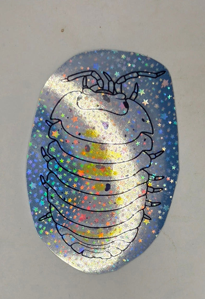 Magic Potion isopod sticker: a pale outlined pill bug with yellow patches and black flecks, seen from above on star vinyl.