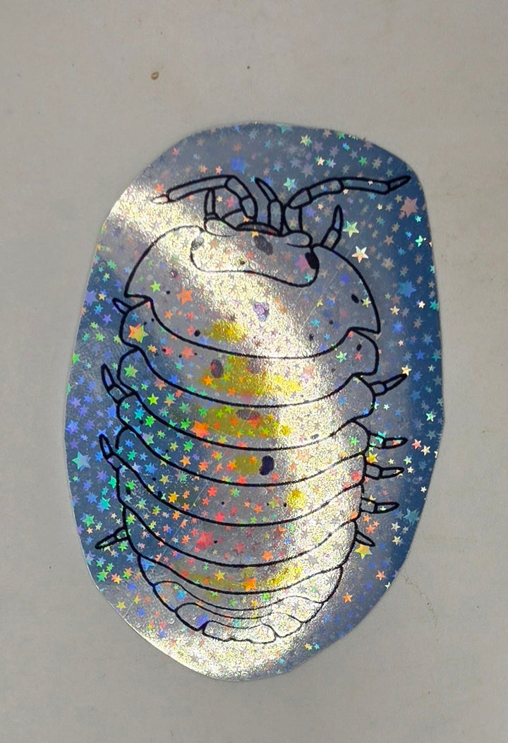 Magic Potion isopod sticker: a pale outlined pill bug with yellow patches and black flecks, seen from above on star vinyl.