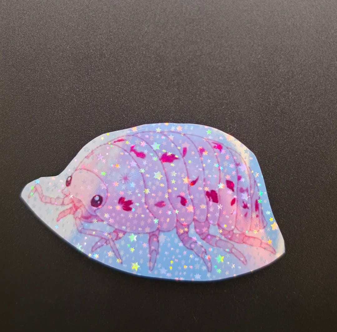 Sticker of a pink and lilac isopod patched with magenta, on a pale blue ground with a star glitter finish.