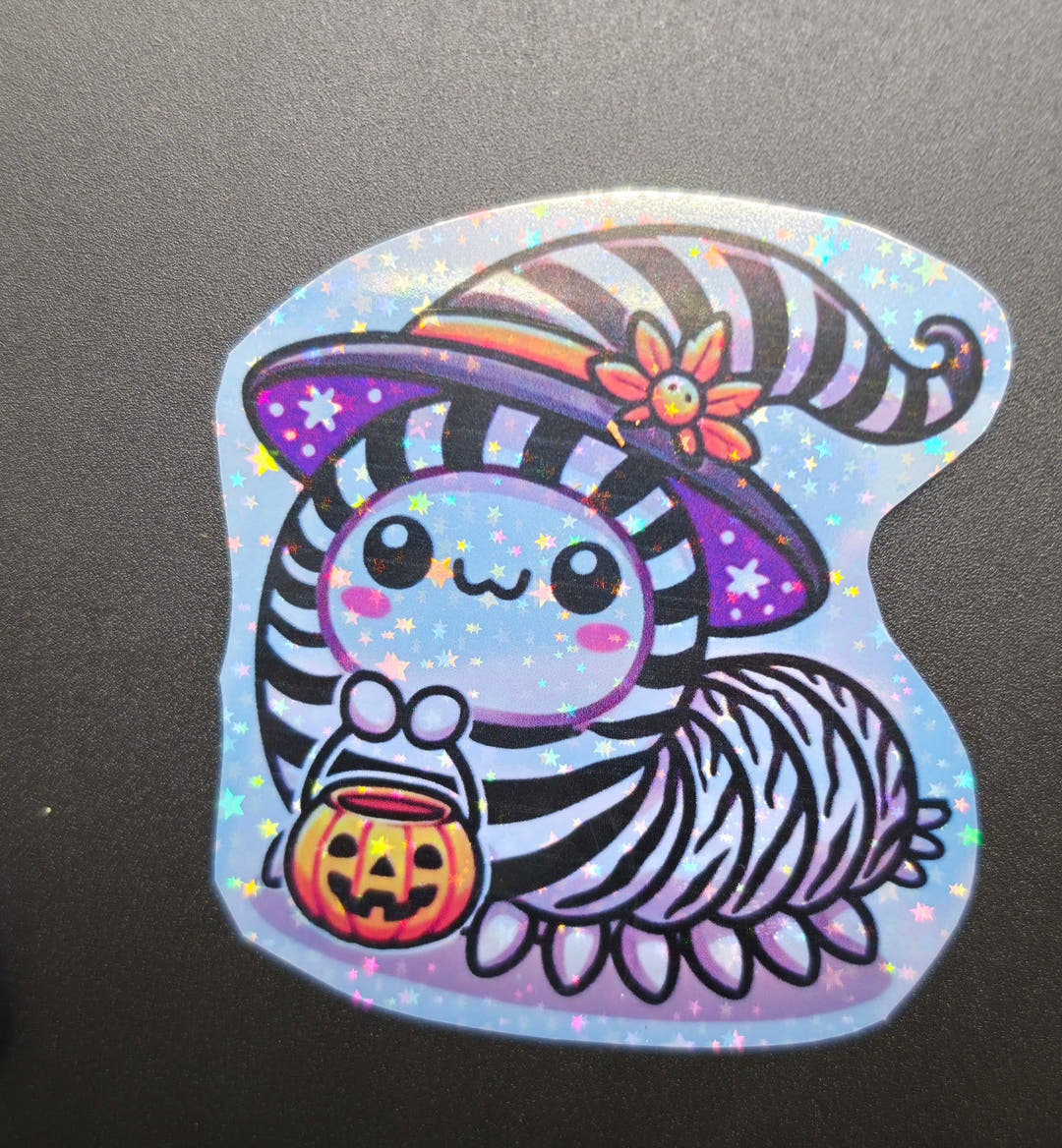 A glittery sticker of an isopod in a tall striped witch hat holding an orange pumpkin bucket.