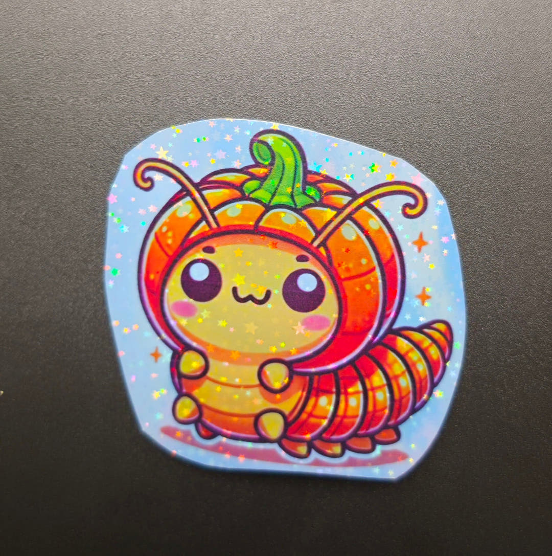 A glittery sticker of a cheerful isopod with an orange pumpkin for a shell and curled antennae.