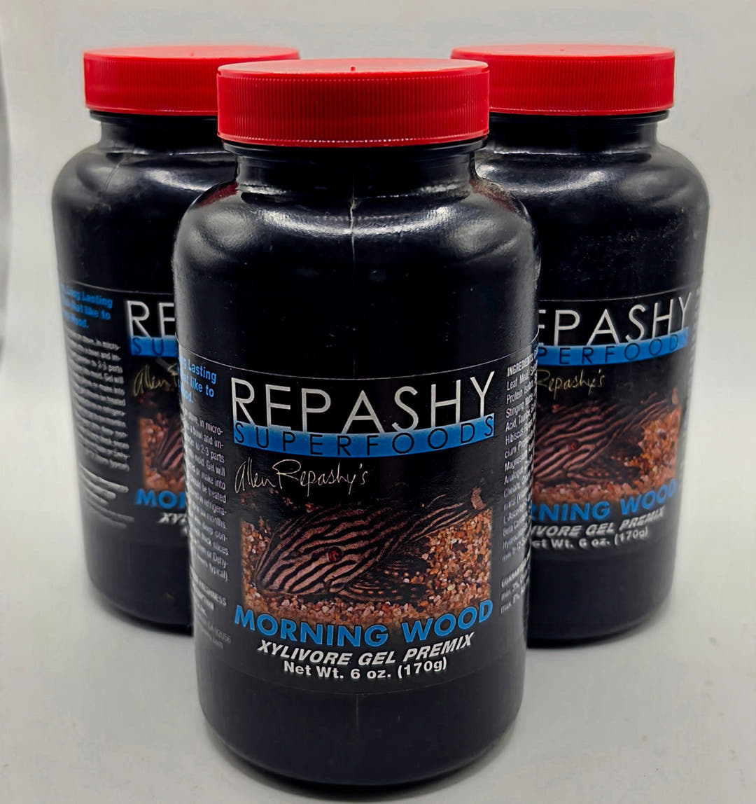Three tall black Repashy Morning Wood jars with red lids, one in front labelled Net Wt. 6 oz (170g) and two blurred behind.