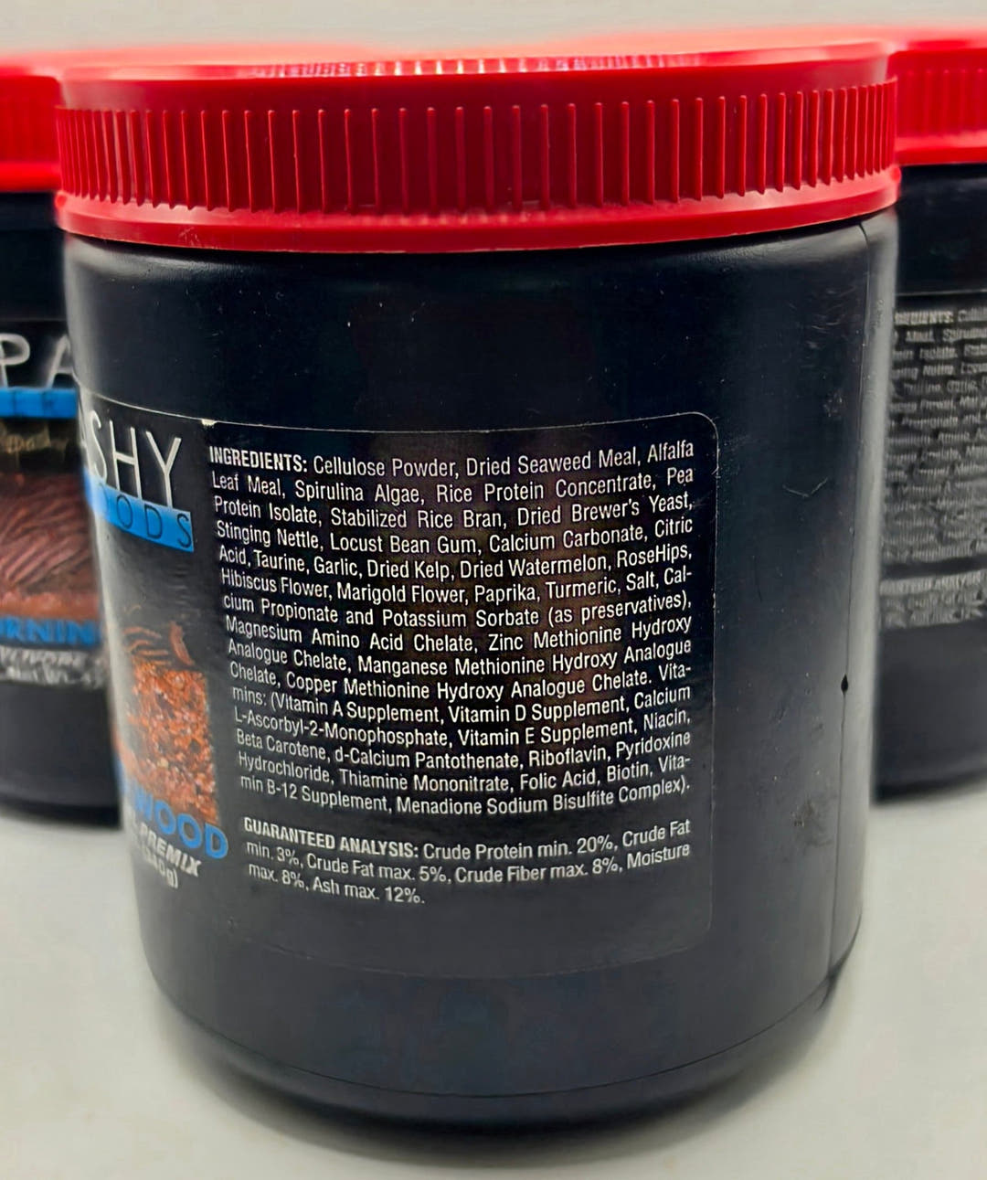Close view of the ingredients and guaranteed analysis panel on the side of a Repashy Morning Wood tub.