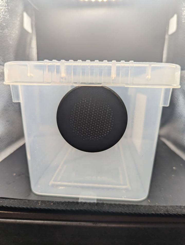 A black screw-in air vent fitted through the side of a clear plastic tub.