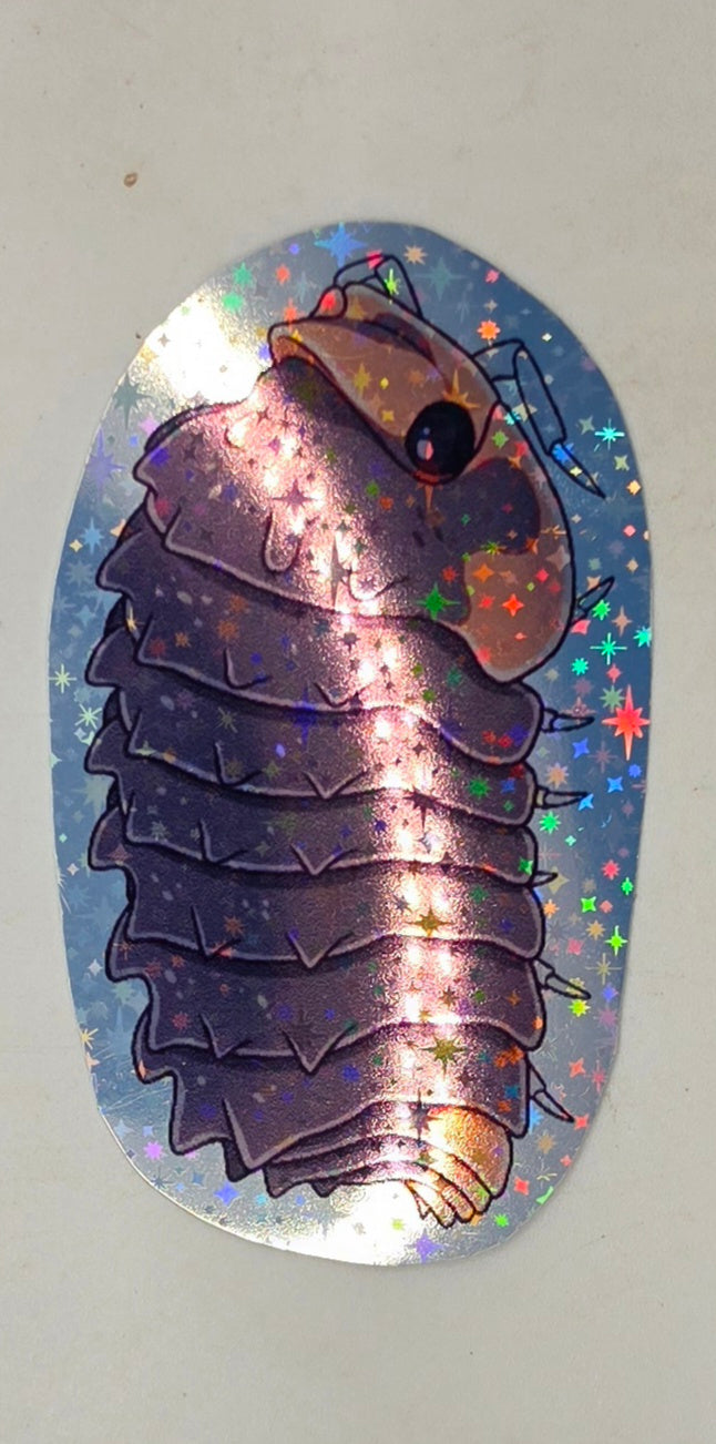 Shiny Gator isopod sticker: a knobbly mauve isopod with a peach face and tail, drawn side-on on holographic star vinyl.