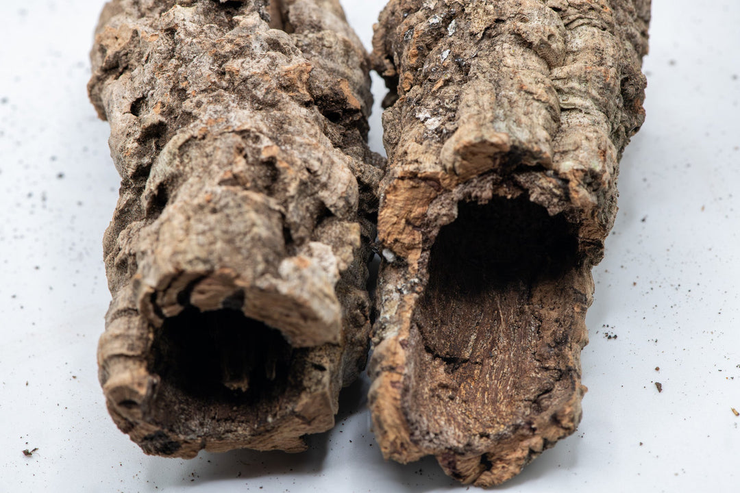 side by side light brown and dark orange tubes of cork
