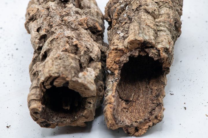 side by side light brown and dark orange tubes of cork