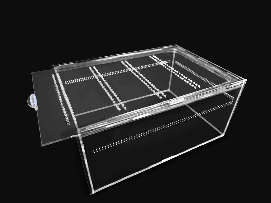 Clear acrylic enclosure with the lid slid across the open top, rows of vent holes drilled through it.