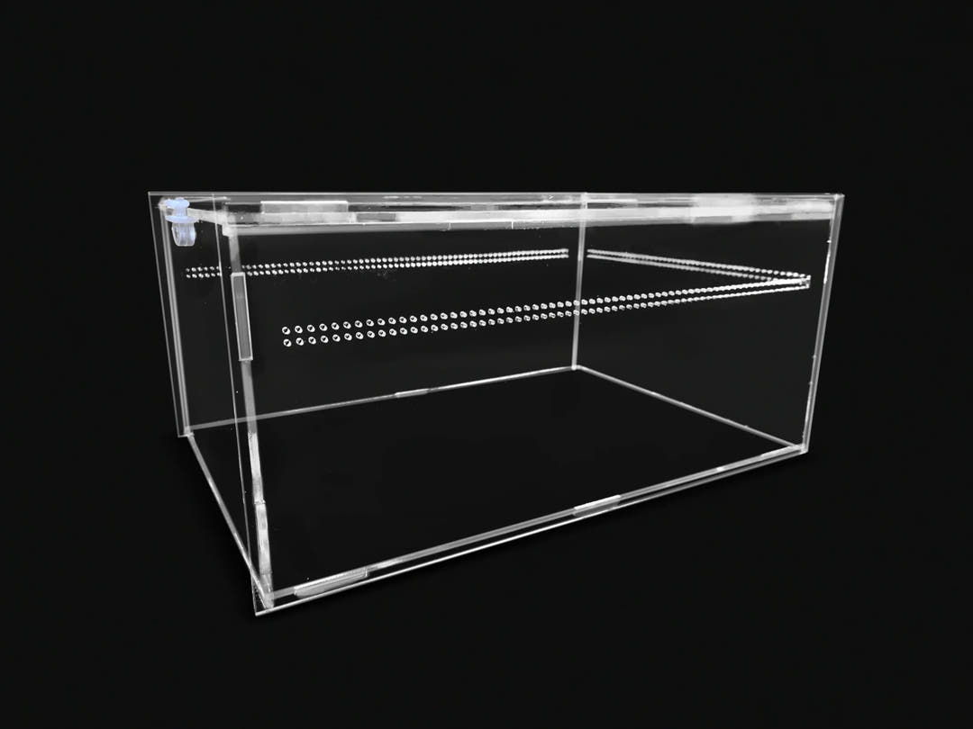 Long low clear acrylic enclosure, lid closed, with two rows of vent holes across the front panel.